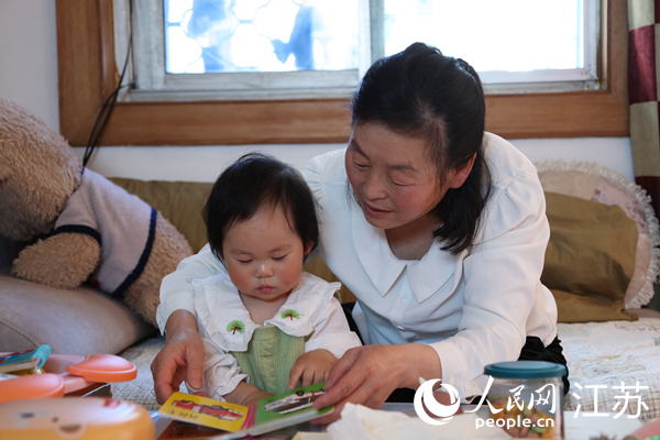 王繼蓮帶孫女看童書。人民網(wǎng) 冷金明攝